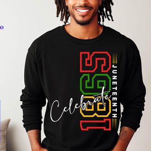 May include: Black long-sleeved shirt with a graphic design featuring the numbers 1981 in red, green, and yellow, with the word "Celebrate" in white script and the text "Juneteenth" in white.