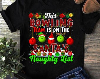 May include: Black t-shirt featuring a Christmas bowling design. The text says "This Bowling Team is on the Santa's Naughty List." The design includes bowling balls decorated as ornaments and Santa hats.
