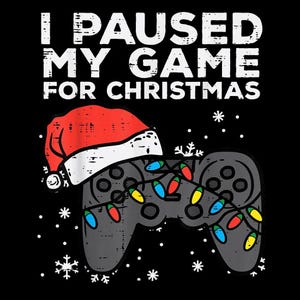 May include: Black graphic tee with the text "I PAUSED MY GAME FOR CHRISTMAS" in white. A gray game controller is decorated with Christmas lights and a Santa hat. Snowflakes are scattered around the controller.