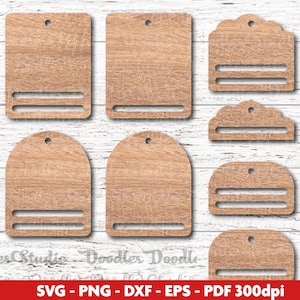 May include: A collection of wooden tags in various shapes, including rectangular, arched, and scalloped designs. Each tag features a slot and a hole for hanging. The tags are made of light brown wood with a visible grain.