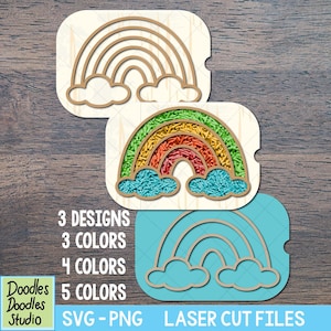 May include: Three rainbow designs in various colors are displayed. One is filled with colorful sprinkles, another is a wood cutout, and the third is a blue cutout. The image includes text: "3 Designs, 3 Colors, 4 Colors, 5 Colors, SVG-PNG, Laser Cut Files."