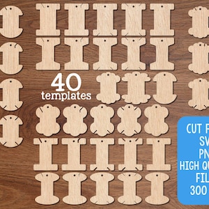 May include: A collection of 40 wooden templates in various shapes, including spools and decorative tags. The templates are arranged on a wooden surface. A blue rectangle displays "CUT FILES SVG PNG HIGH QUALITY FILES 300 DPI".