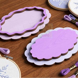 Peut inclure: Deux cadres ovales en bois superpos&eacute;s avec des bords festonn&eacute;s dans des tons de violet clair et fonc&eacute;. Les cadres pr&eacute;sentent une finition lisse et sont pr&eacute;sent&eacute;s avec des tambours &agrave; broder aux motifs de flocons et du fil &agrave; broder violet.