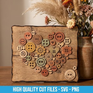 May include: A rectangular wooden plaque featuring a heart-shaped arrangement of various circular and heart-shaped buttons in shades of brown, tan, and muted green. The bottom right corner displays a circular button graphic with the text made with love.