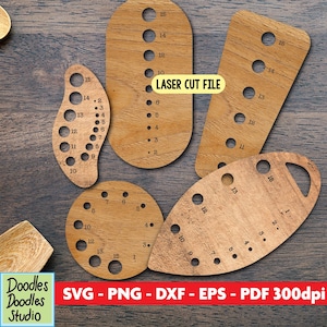 May include: A selection of laser-cut wooden tools with numbered holes, in oval, teardrop, and circular shapes. The text "LASER CUT FILE" is visible. These tools are designed for crafting and DIY projects.