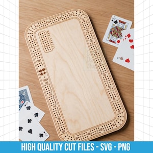 May include: A light-coloured wooden cribbage board with rounded corners, featuring laser-engraved numbers from 1 to 120, a start and finish line, and suit symbols. The board is surrounded by several playing cards, including a Jack of Hearts.