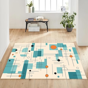 May include: A rectangular area rug with a mid-century modern design. The rug features a cream-colored background with teal, orange, and black geometric shapes and lines. The rug is placed on a hardwood floor.