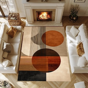 Op de afbeelding: Een beige en bruin geometrisch patroon vloerkleed met grote cirkels en verticale lijnen. Het vloerkleed heeft tinten bruin, zwart en beige, waardoor een modern en abstract ontwerp ontstaat. Het vloerkleed is geplaatst in een woonkamer.
