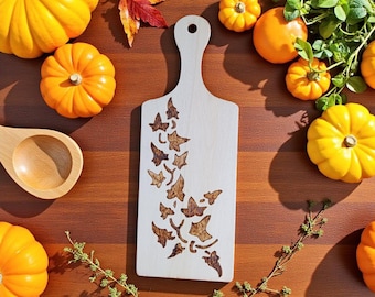 Wooden paddle with pyrography design done by hand.