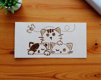 Pinewood panel featuring three mischievous cats. Burned by hand using pyrography.