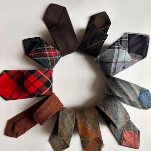 May include: A selection of vintage neckties displayed in a circle. The ties feature diverse patterns such as plaid and stripes, alongside solid-colored options. The colour range includes red, green, blue, brown, and orange, with different textures.