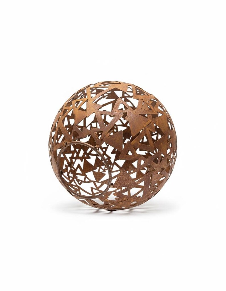 May include: A spherical, openwork metal sculpture with a rusted brown finish. The sphere is constructed from interconnected triangles, creating a geometric pattern. The design allows light to pass through, creating interesting shadows.