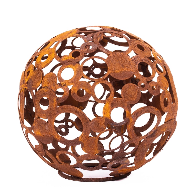 May include: A spherical, decorative metal sculpture with a rusted finish. The sphere is composed of overlapping circles of varying sizes, creating an open design. Suitable for outdoor use, it adds a unique touch to any garden or patio. The sculpture is made of metal.