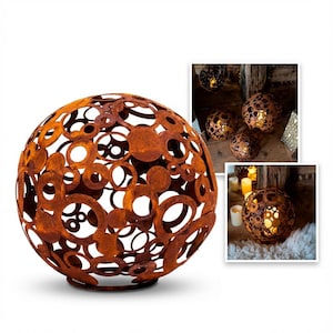 May include: A large, spherical, rusty metal decorative orb with a pattern of cut-out circles and ovals. The orb sits on a circular base. Additional images show the orb lit from within, creating a warm glow, and other similar orbs.