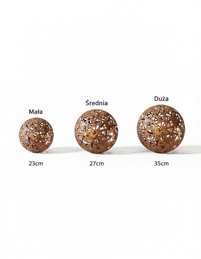 May include: Three bronze-coloured metal spheres with decorative cut-out patterns. The spheres are of varying sizes, with diameters of approximately 23 cm, 27 cm, and 35 cm. The image includes the text "Mała", "Średnia", and "Duża".