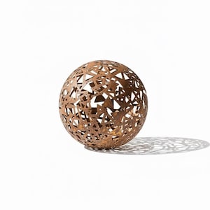 May include: A decorative metal sphere with a rusted brown finish. The sphere features a geometric pattern of cut-out shapes, creating an openwork design. The sphere casts a shadow on the white surface.