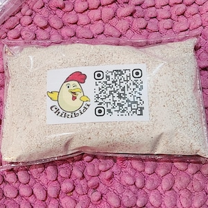 May include: A clear plastic bag filled with a white powder. The bag has a label with a cartoon chicken and the text "Chikibidi" and a QR code.