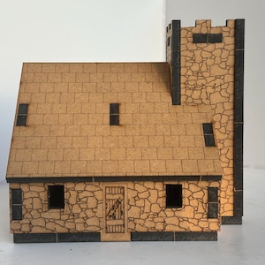 May include: A small, brown, wooden model of a church with a stone facade and a tower. The model has a gabled roof, two windows, and a door. The tower has a small window and a crenellated top.