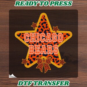 May include: A DTF transfer featuring a large star with an orange and black leopard print pattern, outlined in gold glitter. The text CHICAGO BEARS is printed in orange with a white outline. Four small stars and a bow with the same print are included.