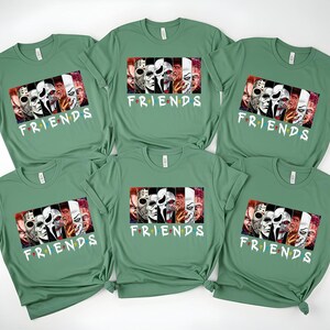 May include: Six green t-shirts with a graphic featuring horror movie characters and the word "FRIENDS" in a colorful font. The graphic includes images of iconic horror movie villains.