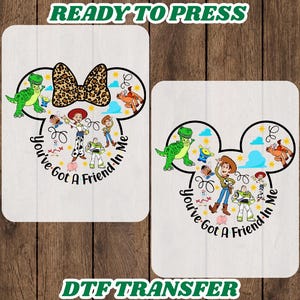 May include: Two rectangular DTF transfer sheets featuring a Mickey Mouse ear silhouette outline filled with Toy Story characters including Woody, Buzz Lightyear, Rex, and Jessie. The text You've Got A Friend In Me is printed below the characters.