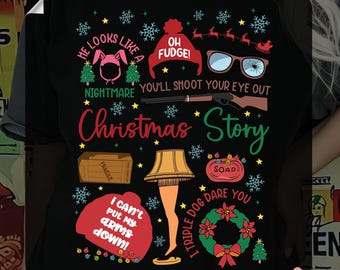 May include: Black t-shirt with a colorful graphic featuring quotes and imagery from the movie "A Christmas Story." Includes phrases like "Oh Fudge!" and "You'll shoot your eye out." Also features a leg lamp and other iconic elements.