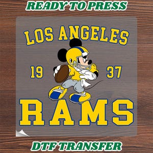 May include: A DTF transfer featuring a cartoon mouse wearing a yellow and blue football helmet and uniform, holding a brown football. The text reads LOS ANGELES 19 37 RAMS, READY TO PRESS, and DTF TRANSFER in yellow, blue, and green lettering.
