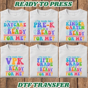 May include: Six white t-shirts featuring colorful retro-style text graphics that read I'm ready for Daycare, Pre-K, Kindergarten, VPK, Fifth Grade, or Sixth Grade, but is it ready for me? Each design includes a peace sign and smiley face icon.