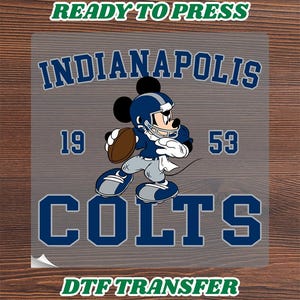 May include: A DTF transfer sheet featuring a graphic of Mickey Mouse wearing a blue and white football uniform and helmet, holding a brown football. The text reads READY TO PRESS, INDIANAPOLIS, 19, 53, COLTS, and DTF TRANSFER in blue and white.