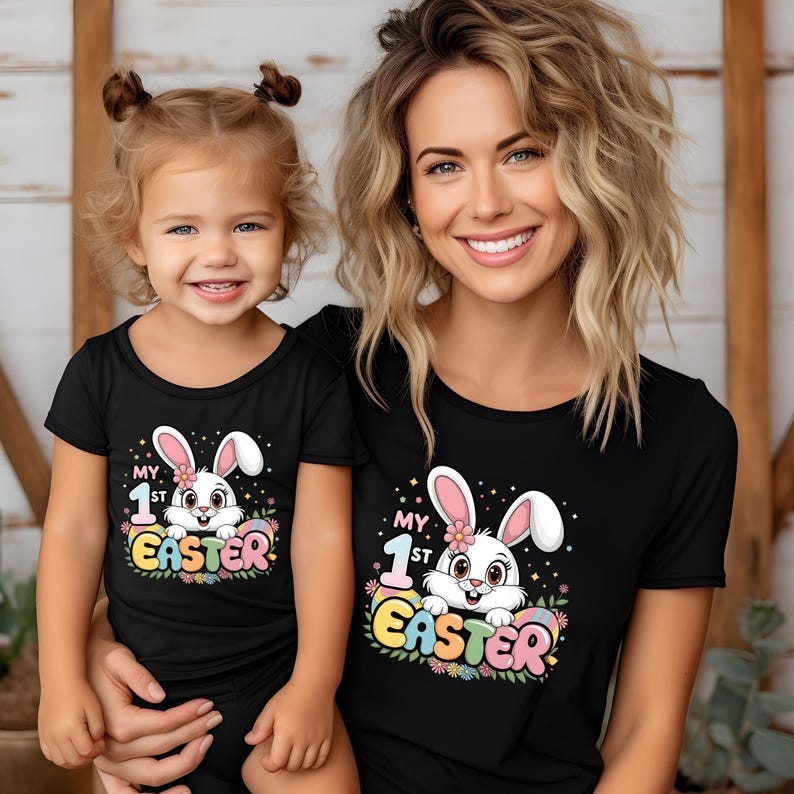 May include: Matching black t-shirts with a white bunny graphic and the text "My 1st Easter". The adult shirt has a larger graphic than the child's shirt.
