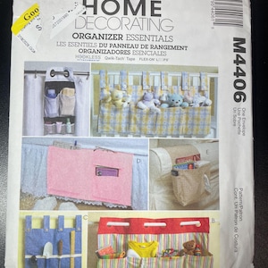 May include: McCall's Home Decorating Organizer Essentials pattern envelope. The cover features images of various fabric organizers, including hanging storage and bed organizers. The envelope is white with text and images.