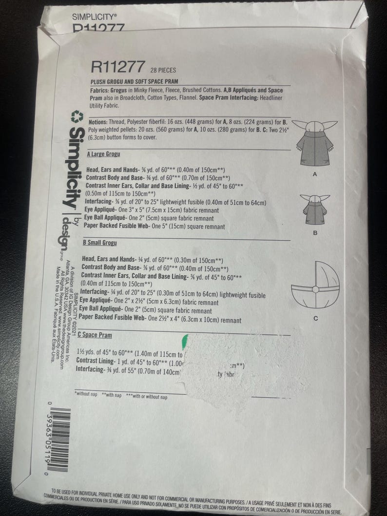 May include: A Simplicity D11277 sewing pattern for a plush Grogu and soft space pram. The pattern includes fabric requirements, notions, and diagrams for creating the character and pram. The pattern includes measurements in inches and ounces.