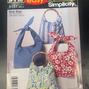 May include: A Simplicity sewing pattern envelope 5151 featuring illustrations of four handbags. The designs include a blue quilted bag with a knotted handle, a striped bag with bamboo handles, a red floral bag with a knot, and a yellow flip-flop print bag.