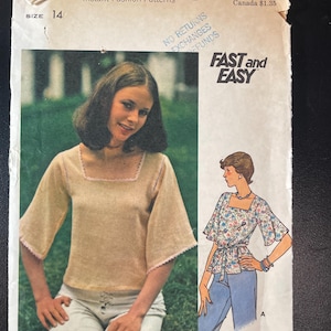 May include: A Butterick 4043 sewing pattern envelope for a top with a square neckline and flared sleeves. The cover features a photograph of a person wearing a beige top with pink trim and an illustration of a floral version with a waist tie.