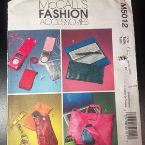 May include: McCall's Fashion Accessories pattern. The cover features a variety of accessories, including a pink tote bag, small pouches, and a wallet. The pattern number is M5012.