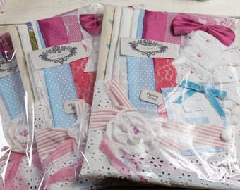 May include: Three packages of fabric scraps and embellishments for crafting. Each package contains a variety of ribbons, lace, fabric, and other decorative elements in pink, blue, and white.