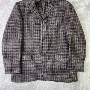 May include: A brown and gray plaid blazer with a two-button closure and two front pockets. The jacket has a classic design and is made of a textured fabric. The blazer is a versatile piece for a variety of outfits.