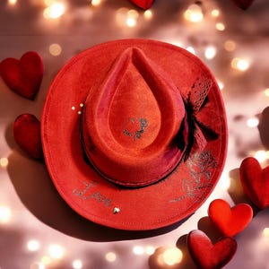 THE VAL is a beautiful red fedora vegan suede hat that has been hand burned.