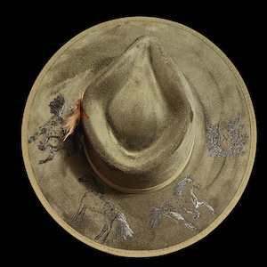 THE APPI is a green hard top fedora in vegan suede. Hand burned with a pyrography tool.