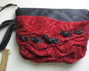 red wrist let black leather trim 10 inches by 8 inches great size...Jasmine is yummy..