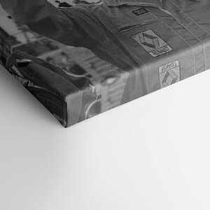 May include: Monochrome canvas print of a racing suit. The suit displays the Renault logo and various patches. The image is a close-up, highlighting the suit's texture and design details.
