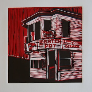 May include: A red and black linocut print of a building with a sign that reads "Lobster Pot Clams & Stews".