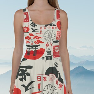 May include: A white dress with a Japanese-inspired print featuring red and black symbols, including a red sun, a red gate, and a red stamp with the text "春風".