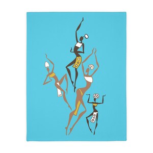 May include: A turquoise blanket featuring a stylized illustration of four dancing figures. The figures are depicted in shades of brown, yellow, and white, with arms raised in a celebratory pose. The design is simple and graphic.