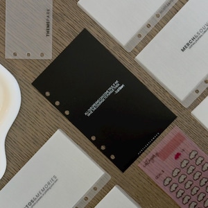 May include: A collection of planner inserts including a black card with the white text ALL OUR DREAMS CAN COME TRUE IF WE HAVE THE COURAGE TO PURSUE THEM - Walt Disney, alongside translucent and white dividers labeled with categories like FOOD & SNACKS.