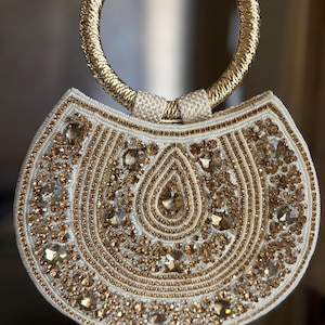 SHANAZ Crescent shape Off white bag with champagne gold and bronze embellishment  and circular top handle, Indian wedding  accessory