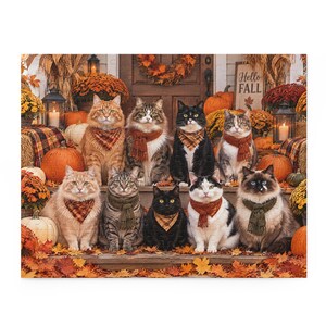 May include: A jigsaw puzzle featuring nine cats sitting on porch steps decorated with pumpkins, autumn leaves, and lanterns. Each cat wears a scarf or bandana in fall colors. A wooden sign in the background displays the text Hello Fall.