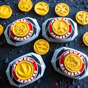 May include: A collection of Power Rangers belt buckles and coins. The buckles are gray with red and black accents, featuring a yellow coin in the center with a Power Rangers logo. The yellow coins have various embossed designs.