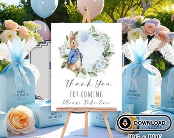 May include: A blue and white baby shower favor sign with a watercolor illustration of a bunny rabbit holding a blue balloon. The sign says "Thank You For Coming Please Take One".