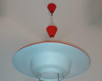 May include: A white and red ceiling light fixture with a saucer-shaped shade and a red cone-shaped top.